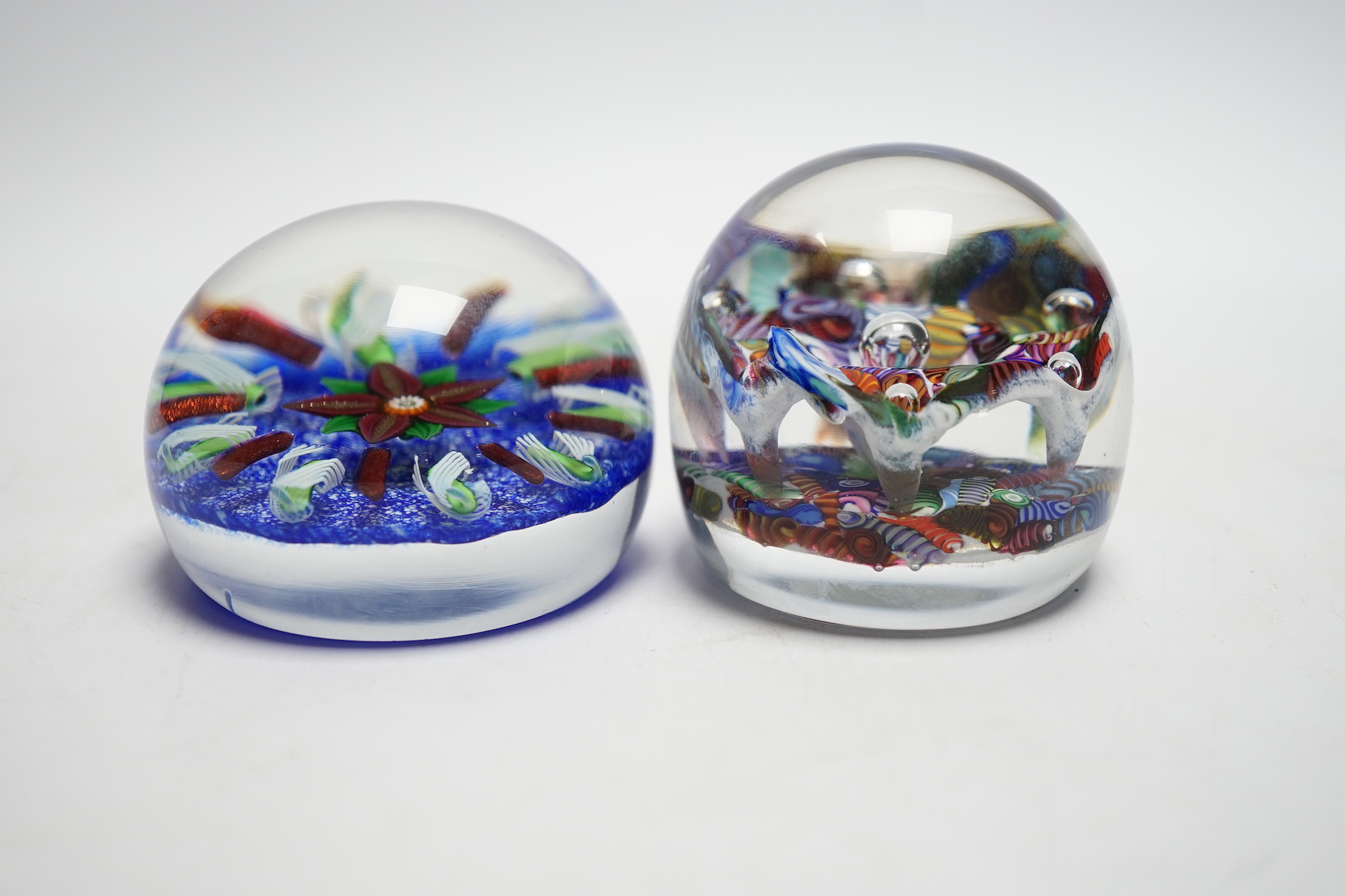 Two Paul Ysart glass paperweight, comprising an anemone surrounded by aventurine and latticino spokes on a blue jasper ground, ‘PY’ cane to underside, 7.5cm, and a ‘Double Harlequin’, PY paper label, 6cm high